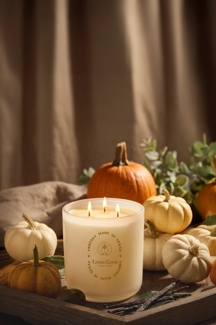 Living Good Candle Co. 15 oz three-wick beeswax candle styled with pumpkins in a warm fall setting, representing clean-burning low-toxic candles.