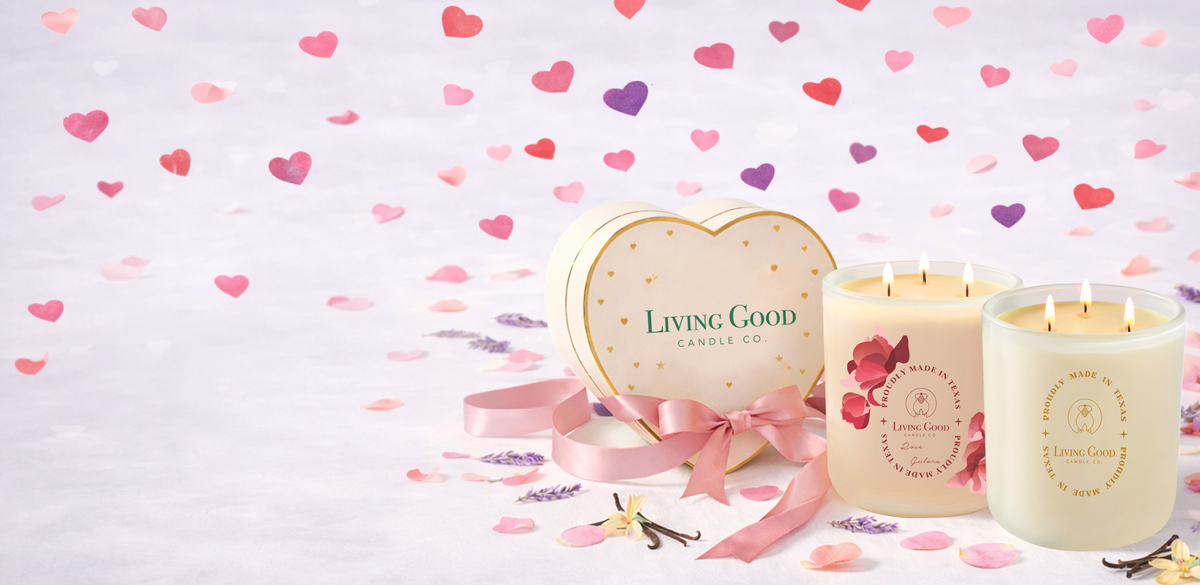 Living Good Candle Co. Rose Gulora and Tranquility 15 oz three-wick beeswax candles styled with a heart-shaped gift box for Valentine’s Day.