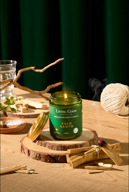 Living Good Candle Co. 5.5 oz Palo Santo beeswax candle styled with natural wood as a clean Mother’s Day candle gift.