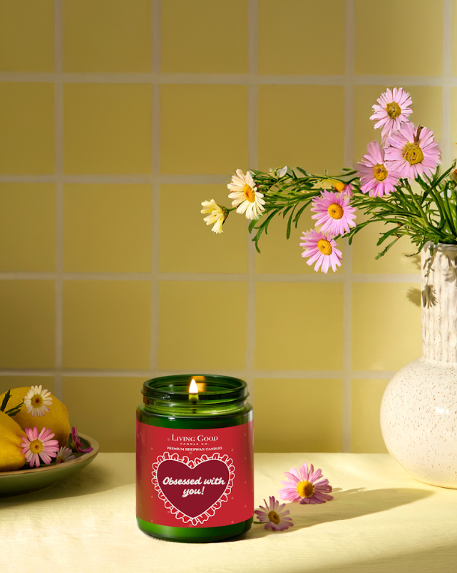 Living Good Candle Co. 5.5 oz personalized beeswax candle with “Obsessed with you!” label styled with flowers for a Valentine’s Day gift.