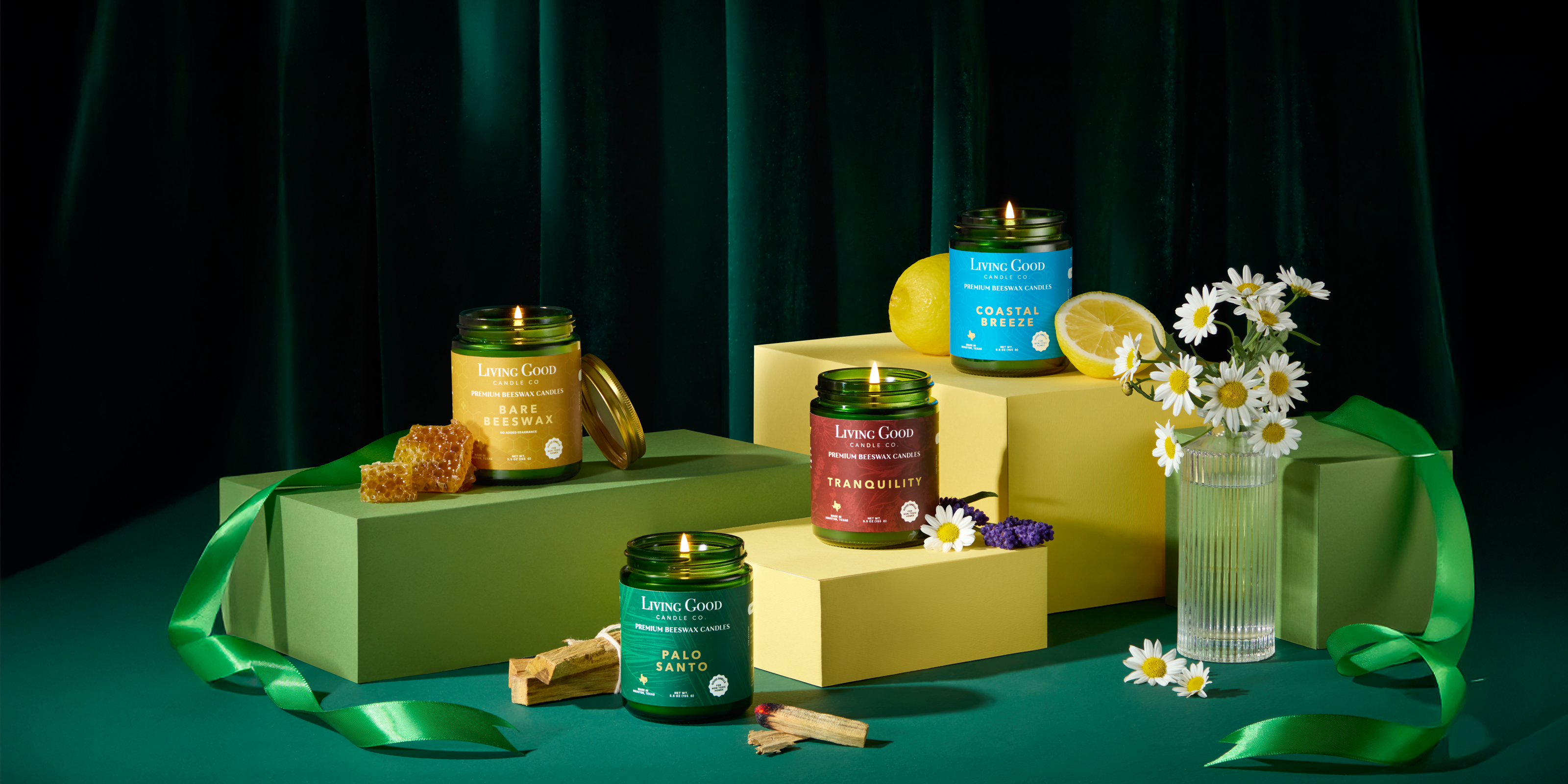 Collection of candles and gift boxes on a green background