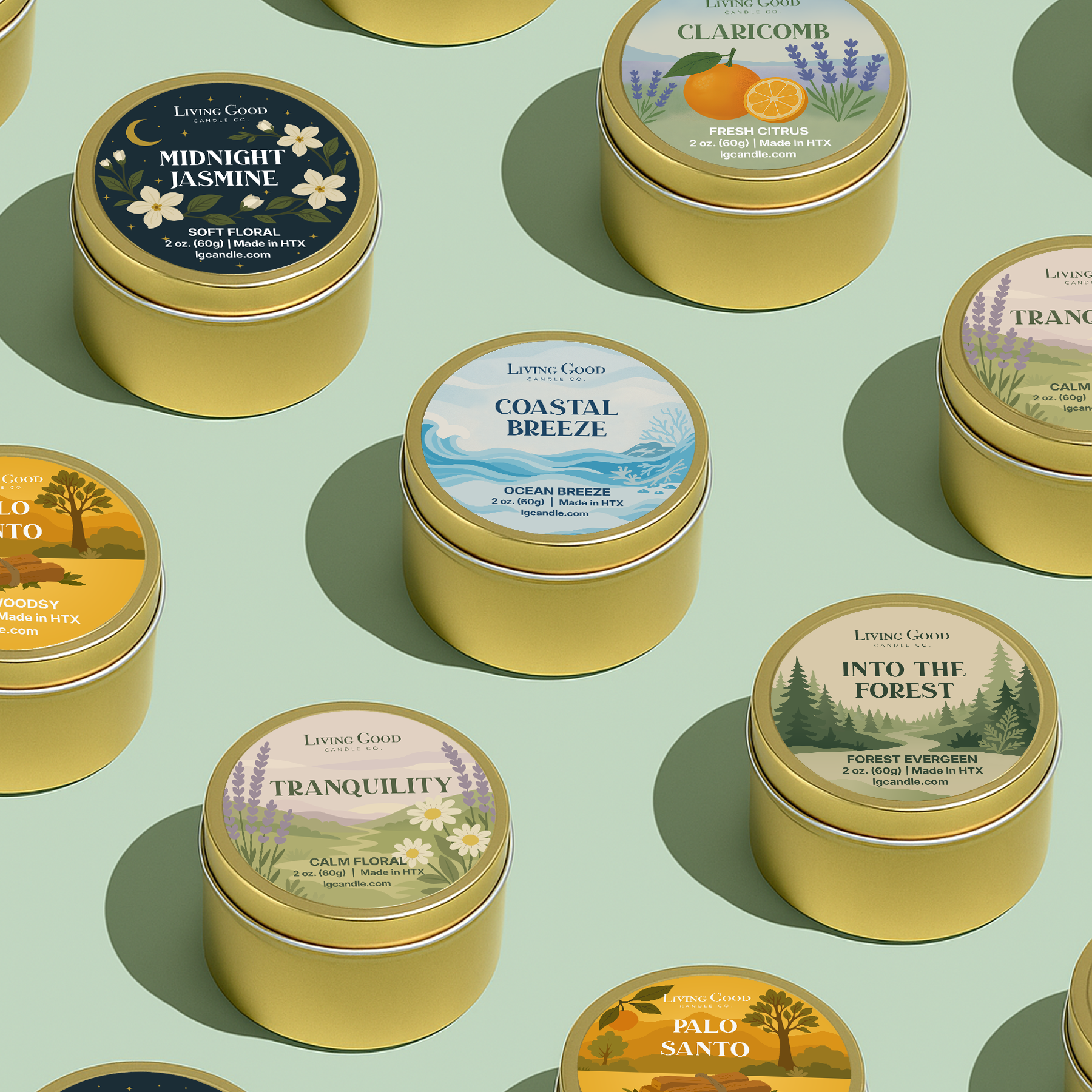 Collection of golden tin candles with labeled scents for Scent Discovery Box on a green background