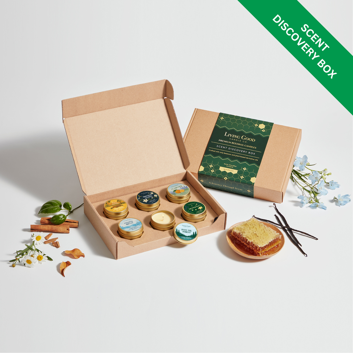 Living Good Candle Co. Scent Discovery Box opened to reveal six mini beeswax candles in gold tins.