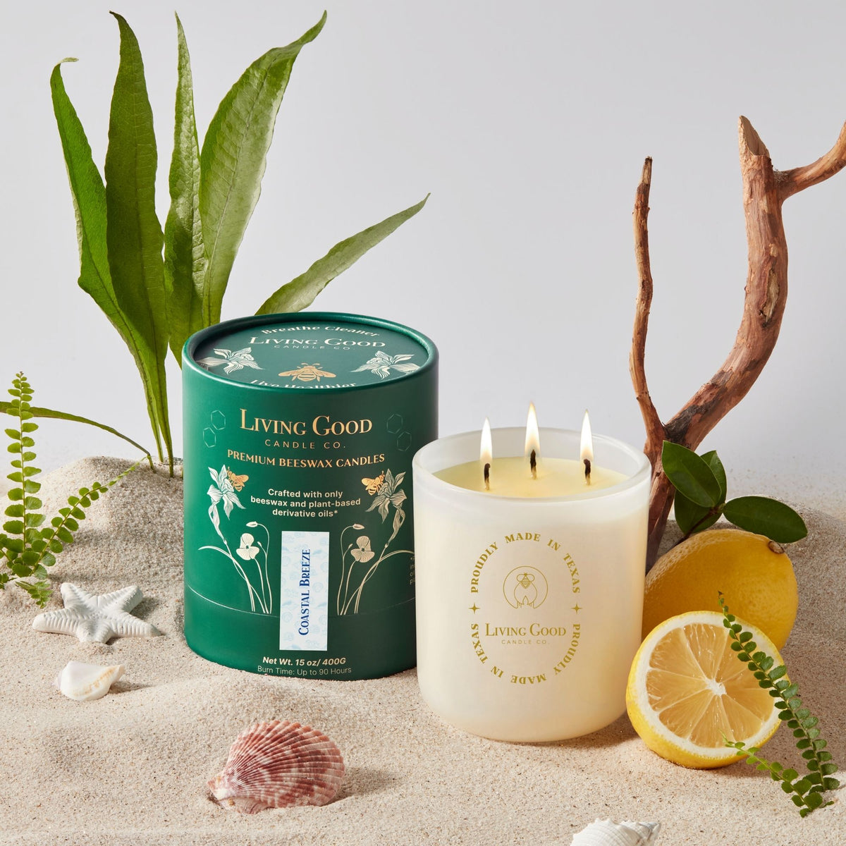 Coastal Breeze 15 oz beeswax candle with three lit wicks, citrus, greenery, and coastal-inspired decor