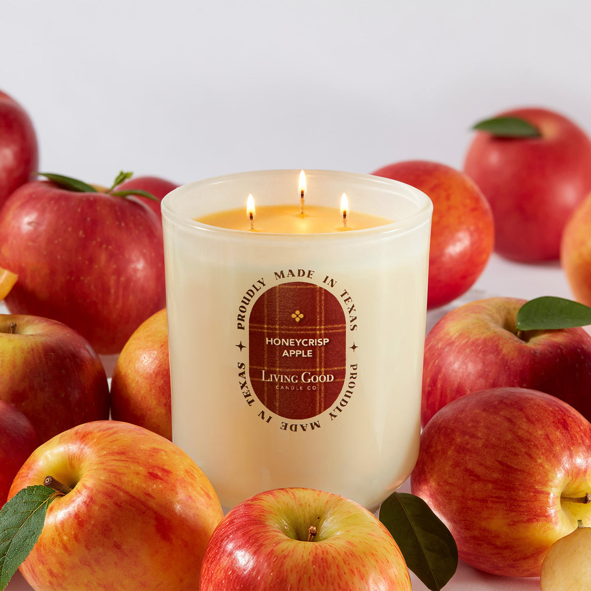 Honeycrisp Apple candle surrounded by fresh apples, Living Good Candle Co.