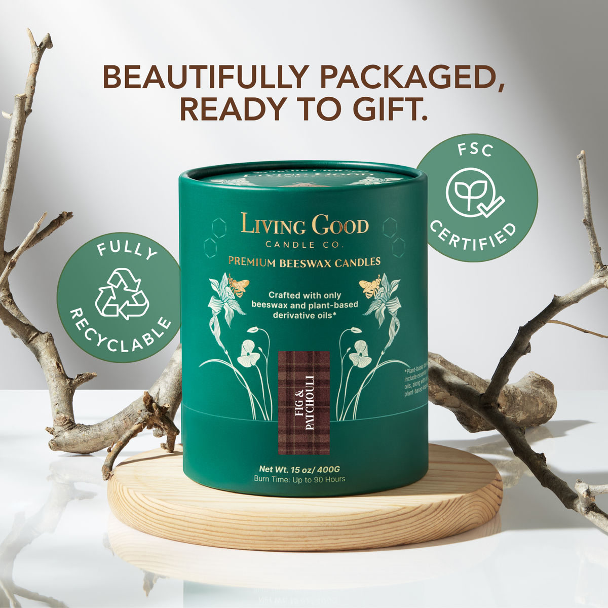 Living Good Candle Co.'s Fig & Patchouli 15oz beeswax candle in a green recyclable gift tube on a wooden stand