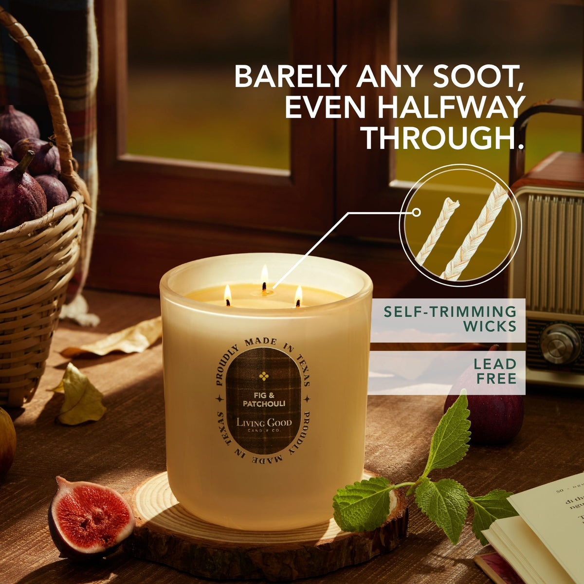 Living Good Candle Co.'s Fig & Patchouli 15oz three-wick beeswax candle burning on a wood slice with a close-up of lead-free self-trimming cotton wicks