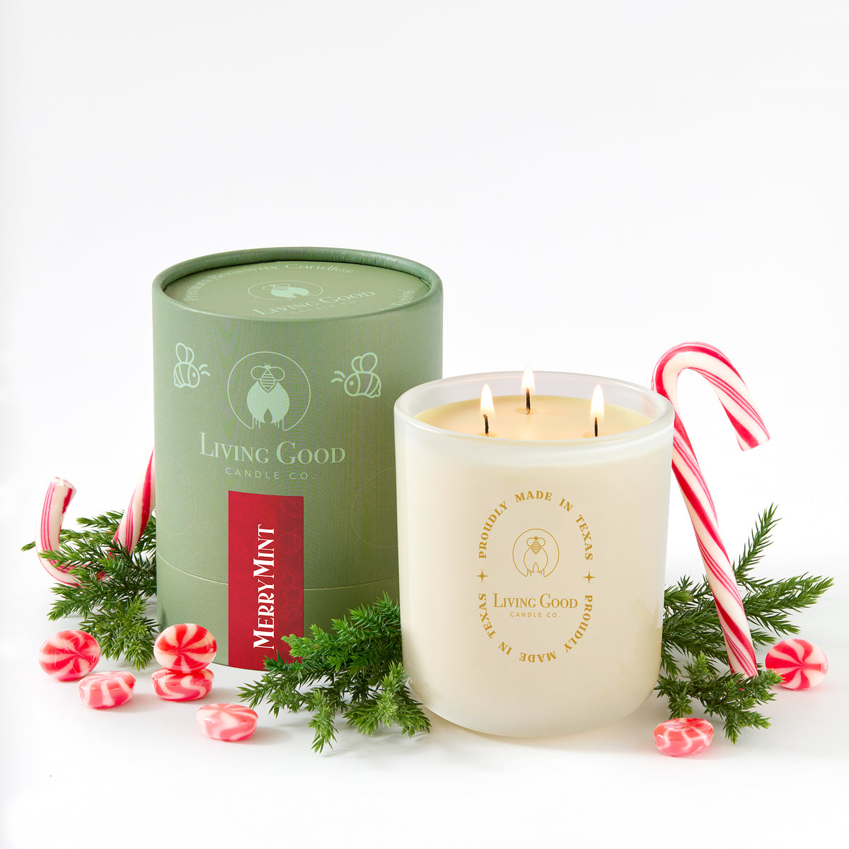 Merrymint beeswax candle with a green tin, candy canes, peppermint candies, and holiday greenery
