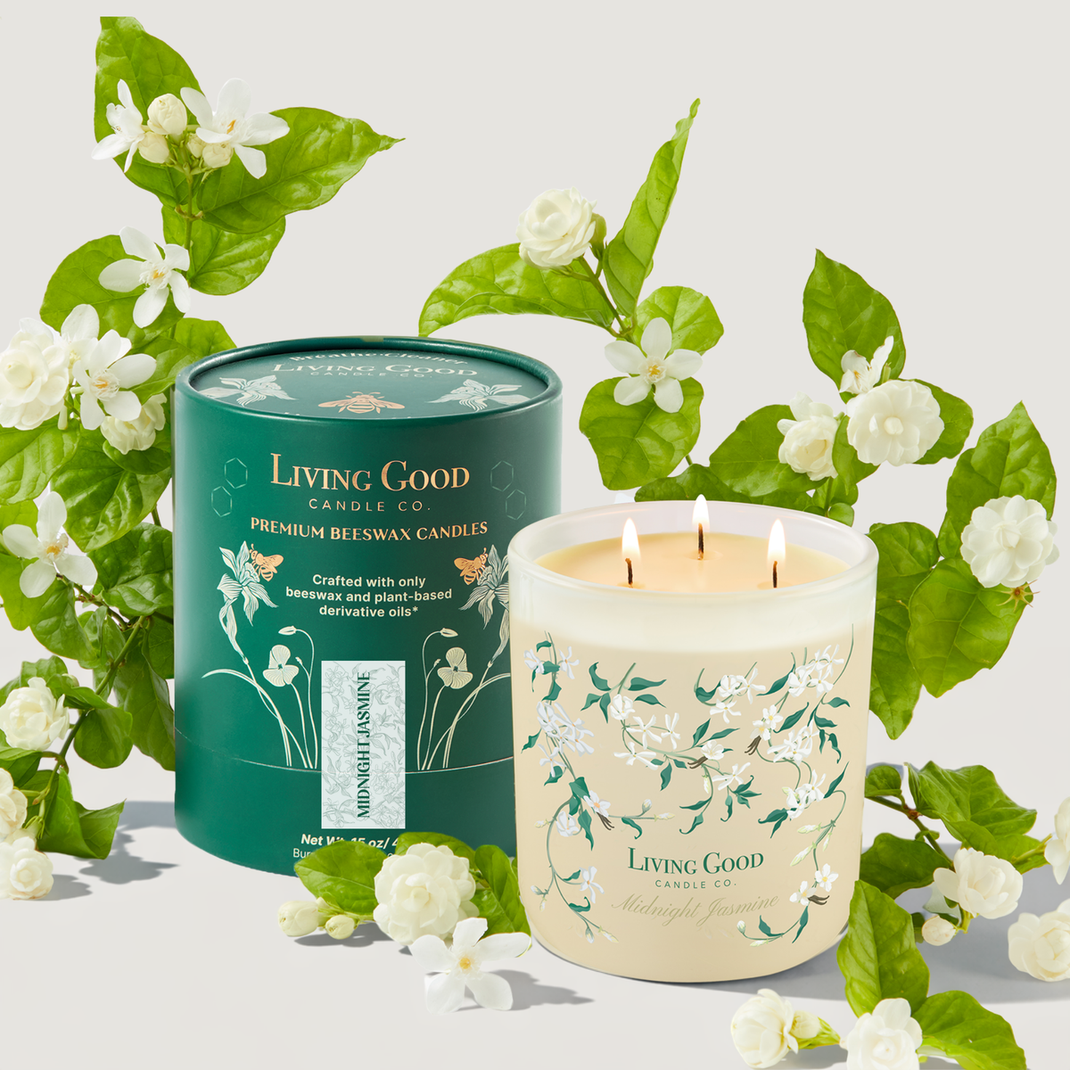 Midnight Jasmine 15 oz beeswax candle with three wicks and Living Good Candle Co. packaging surrounded by jasmine flowers.