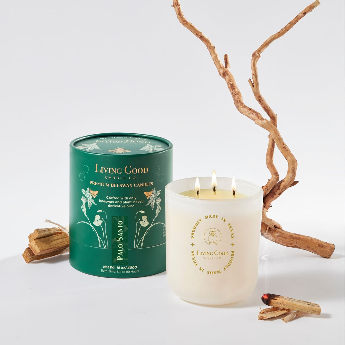 Living Good Candle Co. Palo Santo 15 oz beeswax candle with three wicks, green gift packaging, and palo santo wood.