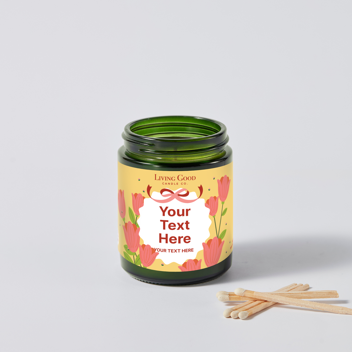 Personalized beeswax candle with a custom message label featuring colorful flowers and a decorative bow design.