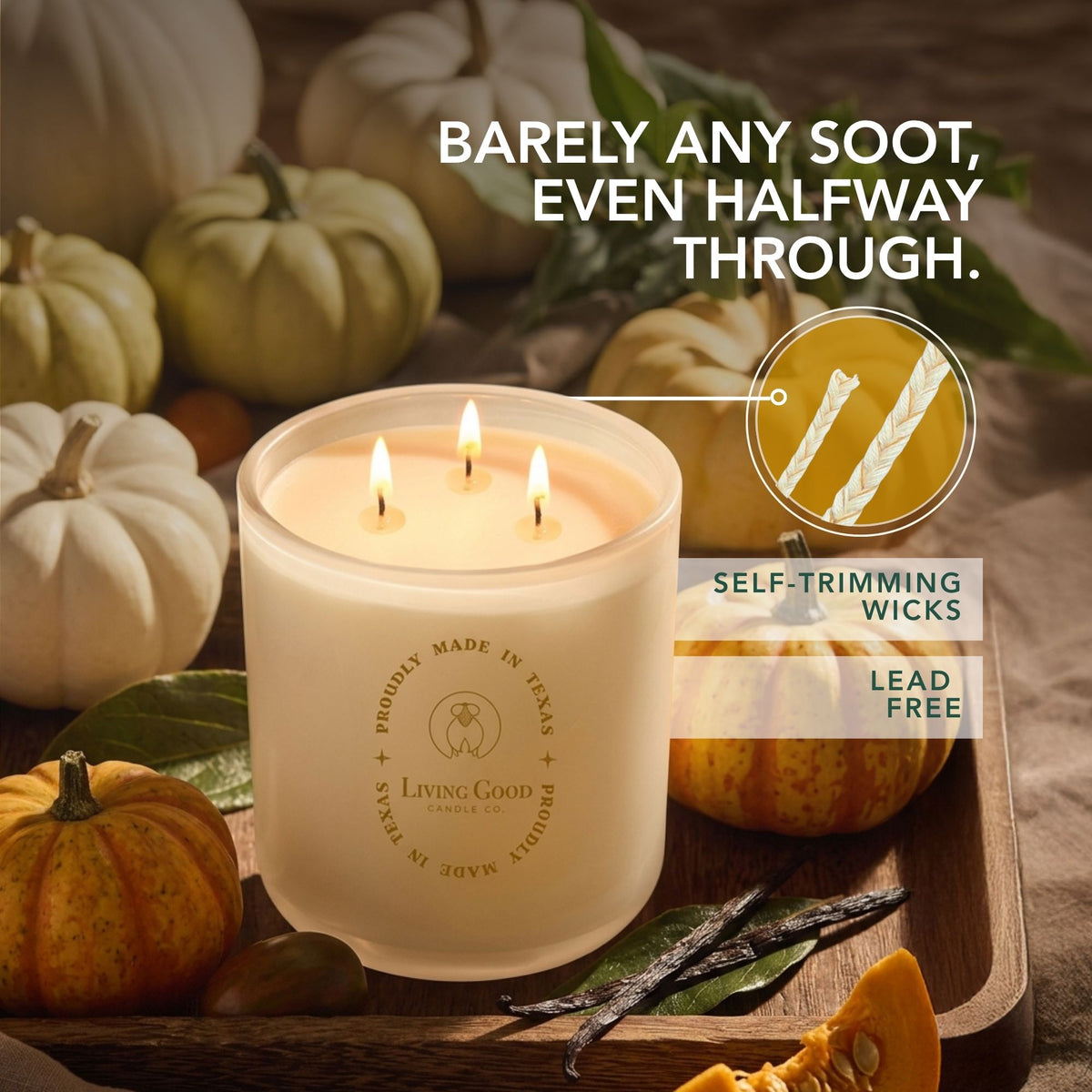 Toasty Pumpkin Brulee beeswax candle with three lit wicks surrounded by pumpkins and fall decor